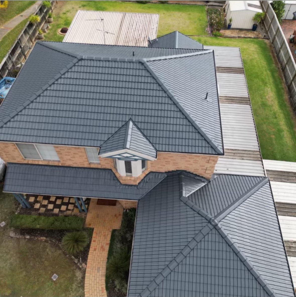 Aerial view of a completed Sydney roof restoration with new grey tiles